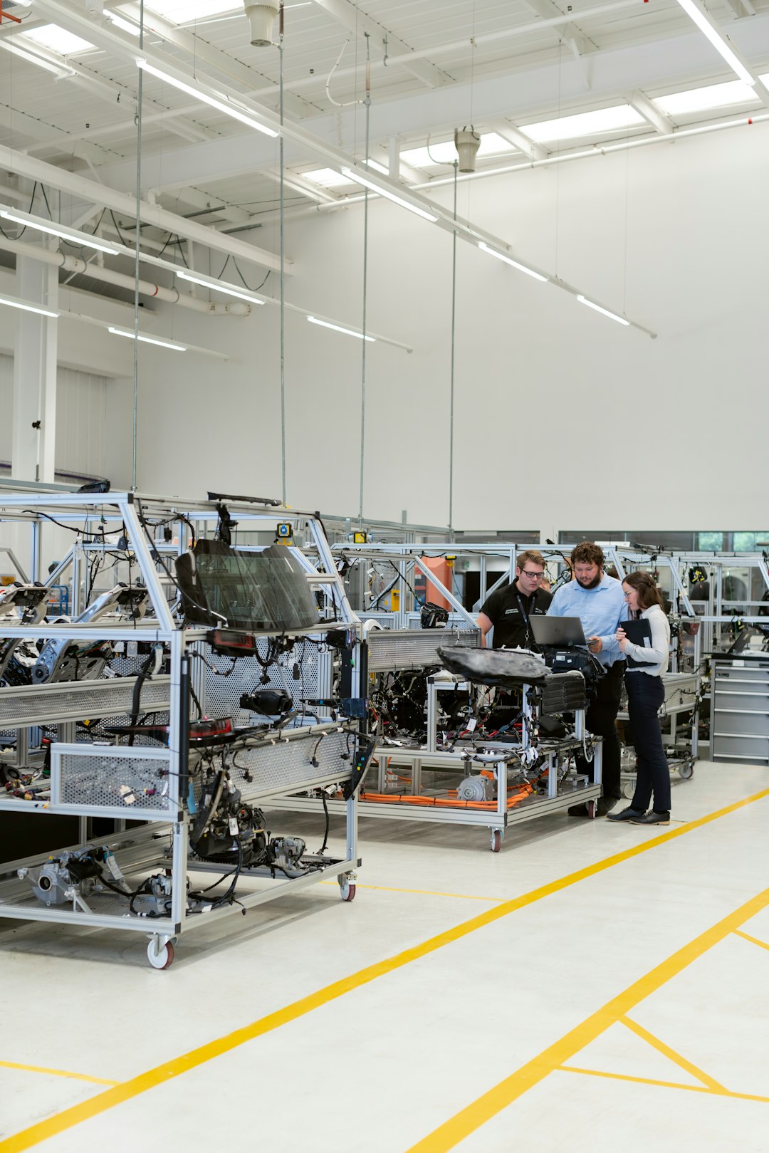 Female electronics engineer tests vehicle software with team